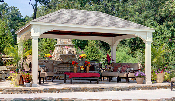 Pavilion with a well decorated, outdoor sitting area and fireplace.