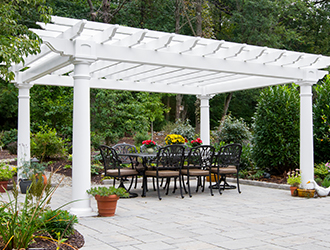 Traditional vinyl pergola over an outdoor dining area.