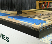 Poly lumber being cut to shape by a CNC machine.