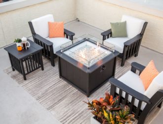 Coffee table with fire feature, deep seating chairs, and side tables.