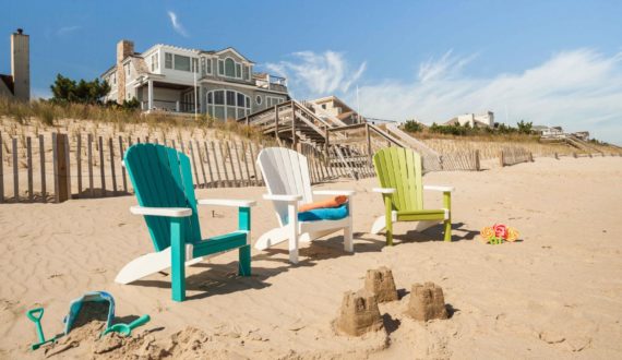 three poly adirondack chairs on the beach
